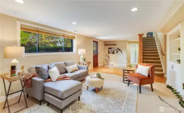 In the lower level is a delightful family room with built-ins, a fireplace, and convenient access to the private backyard.