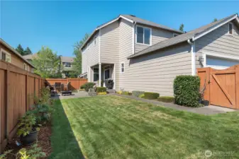 Backyard that features an upgraded extended patio and garden space.