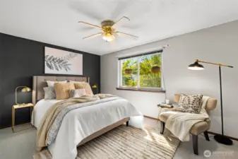 Bright primary bedroom with fresh paint and new carpet