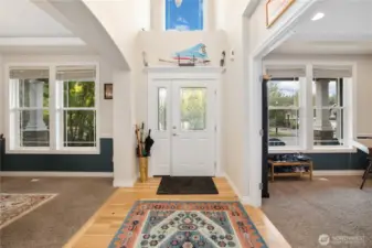 Entry flanked by formal dining room and den