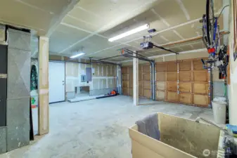 Spacious garage with sink  and man door to the side yard.