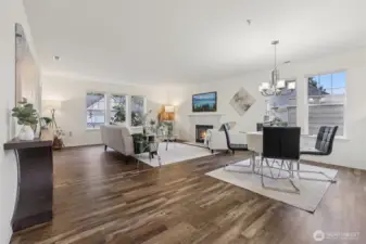 Large living spaces with newer flooring, wood burning fireplace, lots of windows.