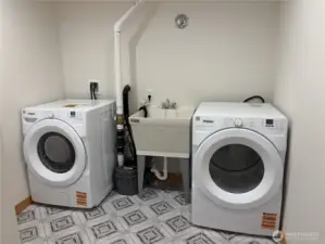 Large laundry room with utility sink.