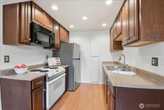Kitchen has new refrigerator, sink and garbage disposal.