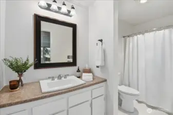 Refreshed bath with new flooring and toilet.