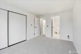 Access to hall and additional vanity from primary room.