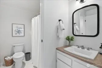 Primary room vanity with access to bathroom.