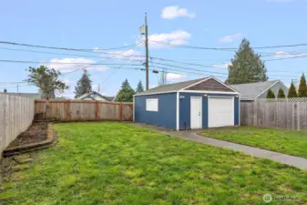 Alley access and fully powered garage W/ Built in storage and lawn equipment/ All items convey.