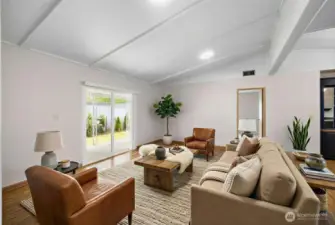 What a large living room! Your vaulted space provides direct access to the covered patio for indoor-outdoor living. Newer LVP flooring runs throughout along with fresh paint. Your primary suite lies directly ahead through doorway. Kitchen and dining lie directly to the right. Open-concept living at it's finest! Photo is virtually staged.