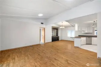 An unobstructed view of your over-sized living space fully integrated with dining and kitchen. Notice the newer skylight tunnels above, newer flooring, and paint. Great entertaining space!