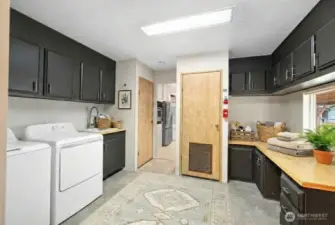 What a laundry space! Tons of built in storage with full sized pantry. This space has direct access to the carport and lies directly off the kitchen! Washer and dryer stay.