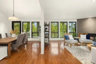 Open living and dining spaces with expansive windows capture the views of Lake Washington and the Cascades