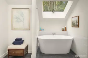 Designed for relaxation, the spa-inspired bath showcases a freestanding soaking tub beneath a skylight, bringing natural light and calm into the 2026-renovated retreat