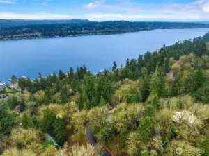 Perfectly positioned on Mercer Island, this aerial view highlights the home’s private wooded setting and beautiful outlooks across Lake Washington