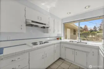 Huge kitchen window, adorable white tile counters and those forever well-made cabinets