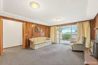 Brick fireplace, wood burning stove, slider leads out to walk-out deck to the side yard