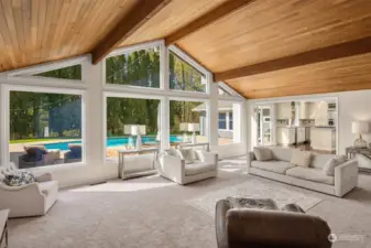 Incredibly spacious family room with wall of windows looking at pool area