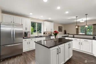The kitchen features ample storage and includes convenient bar seating ideal for casual dining or entertaining.