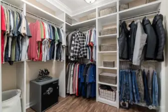 Primary bedroom boasts a spacious walk-in closet with built-ins for shoes, clothes, laundry, etc.