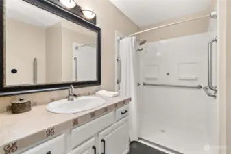 Spacious full-size guest bathroom with ADU assessible shower equipped with grab bars completely remodeled.
