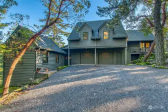 Entrance to the main portion of the home for guests is at the right. The owners typically use the garage entrance which leads to a lower level mudroom. The left wing houses a guest rm/office with private bath.