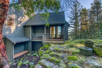 Main entrance also got new Ipe wood and railing in 2018. The stone steps are a bit uneven, please watch your step. The bench area on the lower left was for wood storage. In 2023 the owners converted the fireplace to a high-efficiency propane insert.