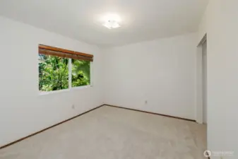 Bedroom 1 overlooking back yard and huge rhododendron