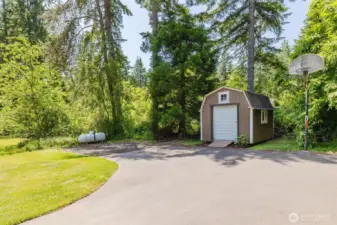 Driveway with space for RV/boat parking and a storage shed for yard tools
