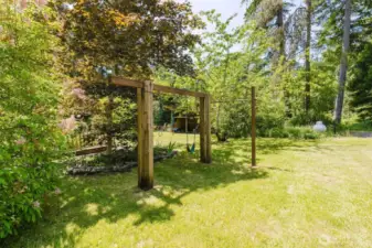 Play set next to "secret garden" that leads to another outbuilding that has been used as a play house