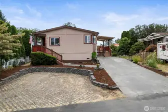 Front view of newer home for sale in 55 older Ranier Manor nicely landscaped,Rv Parking,trext decking and 2 covered decks ready for newer owners