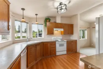 Check out this beautiful large kitchen with new lighting,laminate flooring,lots of cabinets for storage,vaulted ceilings and lots of counter top space