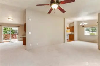 Check out this large great room off front and back of home with earth tone colors all new plush soft carpeting,high ceilings and ceiling fans to stay cool