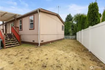 Back yard view of this partially fenced flat yard with room for animals and or garden area