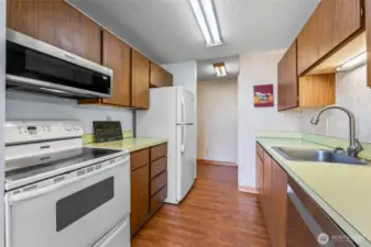 Smooth top range makes clean-up a snap. round the corner to the right is the pantry and laundry...you NEVER have to go upstairs if you choose not to!