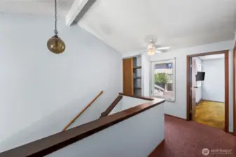 You're upstairs. Storage, natural light and lofty ceiling make it feel really spacious.