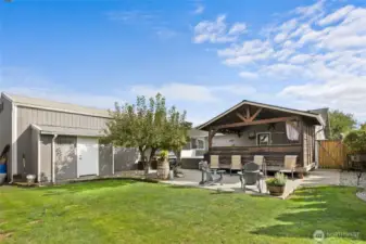 Backyard and Detached shop has attached storage shed perfect for all your yard tools.
