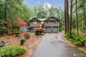Beautifully landscaped front yard with a welcoming driveway and charming curb appeal
