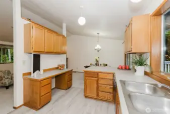 Another shot of the spacious kitchen, showing the built in desk area and even more cabinets! Gorgeous new flooring shows nicely in this photo.