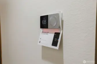 Here's your brand new smart thermostat to operate your brand new furnace and heat pump, on the freshly painted hall wall. The whole has been freshly painted!