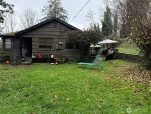 The side yard with chain link fencing.