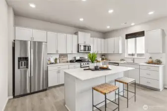Kitchen with shaker style cabinets and stainless-steel appliances. Photo is representational. Actual home is under construction and colors, materials, and finishes may vary. See site agent for details.