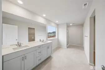 Primary bathroom features double vanity and step in shower. Photo is representational. Actual home is under construction and colors, materials, and finishes may vary. See site agent for details.