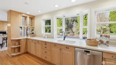 New Milgard windows (found throughout the home) frame a kitchen featuring a Bosch dishwasher and KitchenAid refrigerator. No detail was left undone in this dream kitchen.