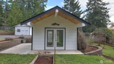 The "She Shed" feature vaulted ceiling and covered patio, waiting to become your private reading nook, favorite craft area, yoga salon, or art studio.