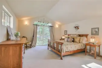 Found on the upper-level, this oversized primary bedroom easily fits a king-size bed, two nightstands and a dresser.