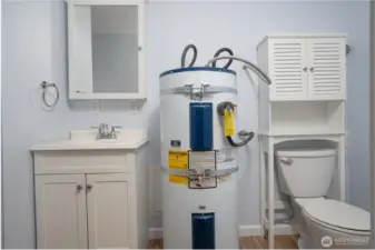 A bathroom is conveniently located just off the mudroom, which has a separate entrance from the main door.