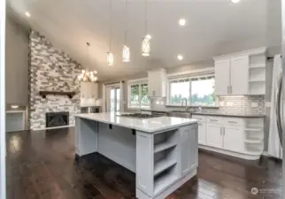 Open concept, newly remodeled kitchen, dining and living area on main floor. High-end appliances, oversized refrigerator, double oven, dishwasher and gas range with built in vent. Gorgeous fireplace with 2 sliders to lake / Mt Rainier facing deck with access to lower patio and lawn