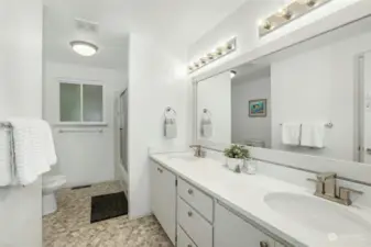 Spacious full hall bath with double sinks & tub/shower combo.