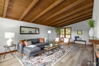 Exposed beams, vaulted tongue in groove ceilings, and wood wrapped windows.