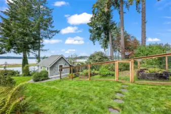 A gardener's dream- meticulously maintained vegetable and flower garden plus spacious gardening shed.